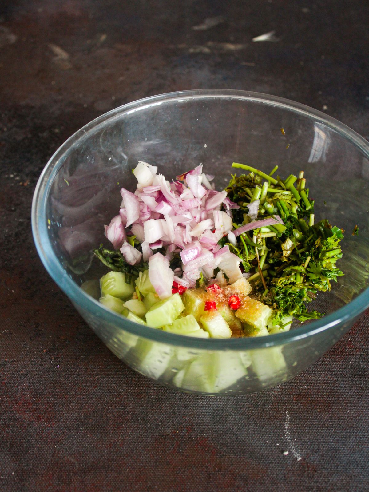 vegetables in large glass bowl on gray counter