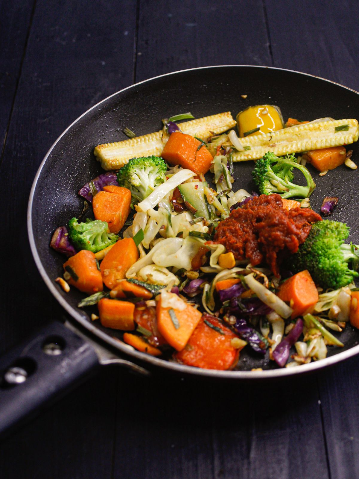 vegetables in skillet with herbs and curry paste