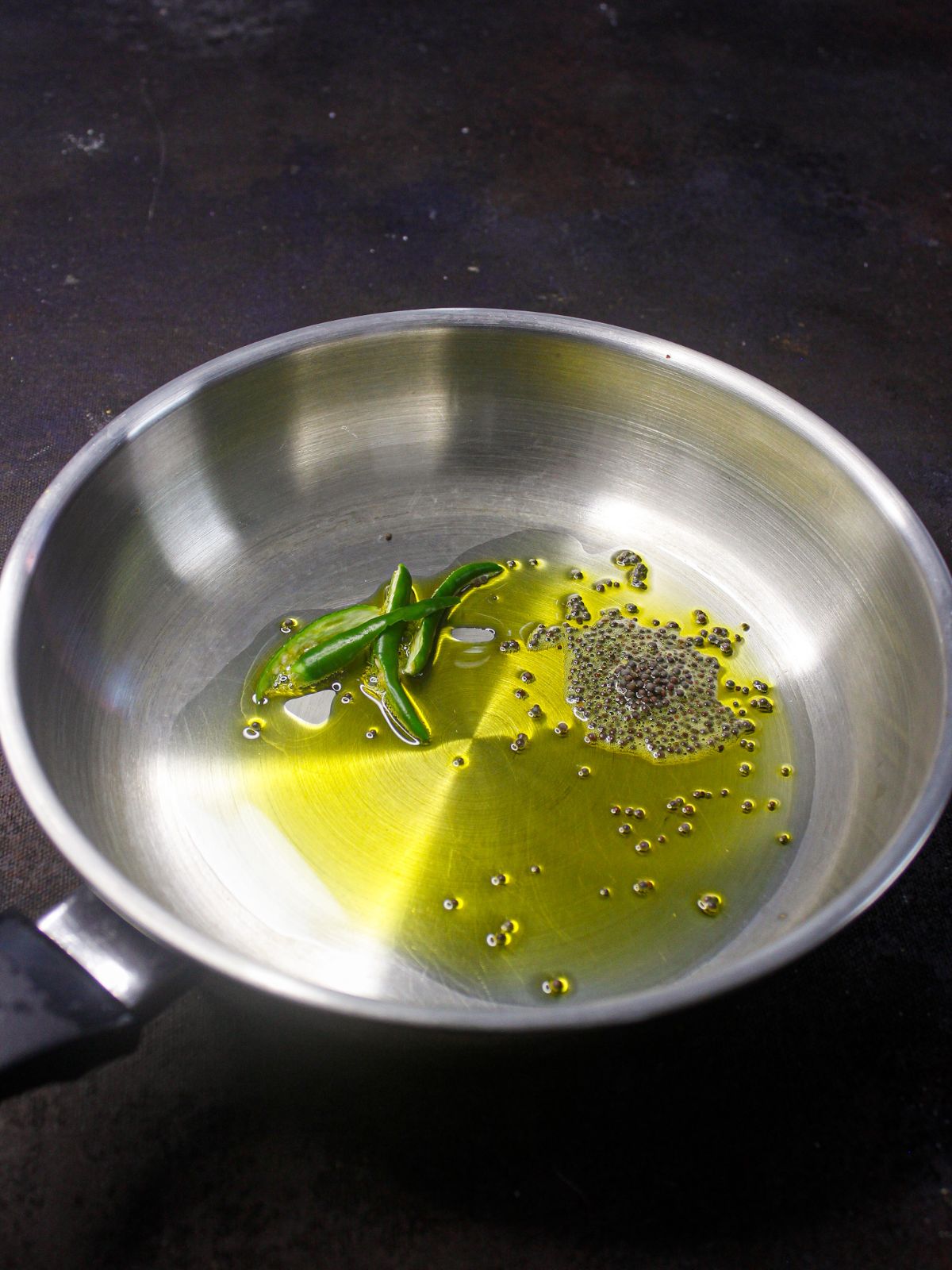 skillet with oil and herbs
