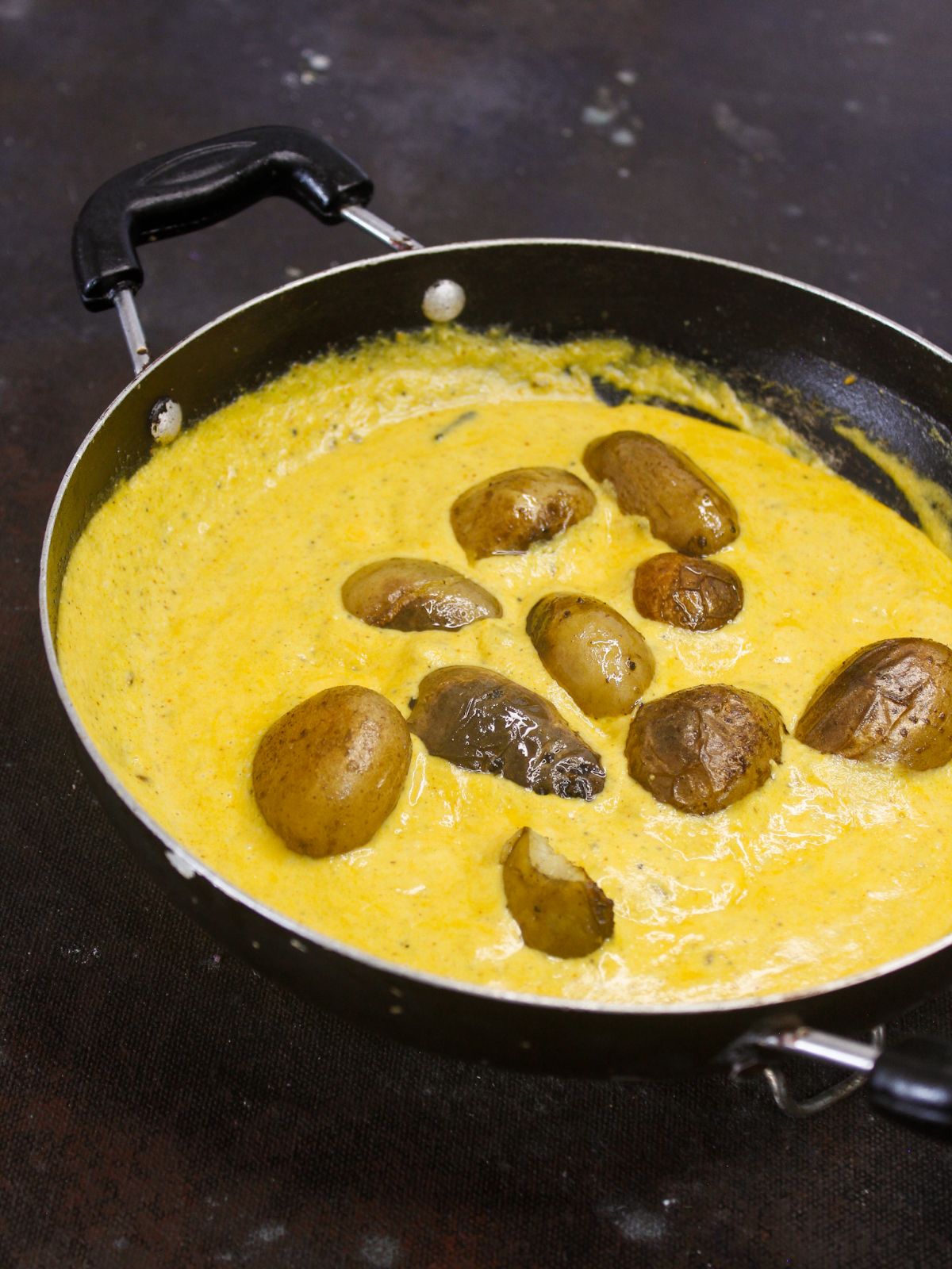 potatoes in yellow curry in skillet
