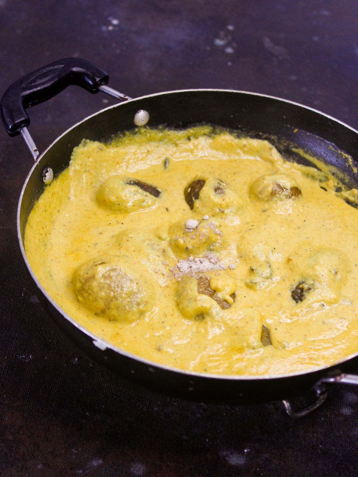 large skillet of yellow creamy potato curry
