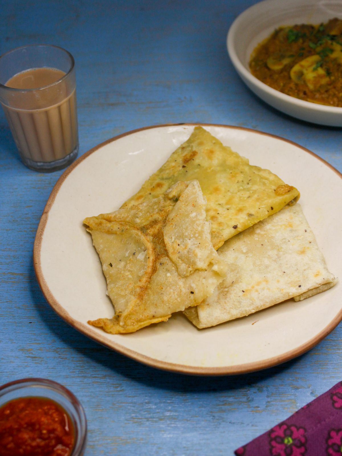 Crispy Sri Lankan Egg Roti served in a plate with chili paste
