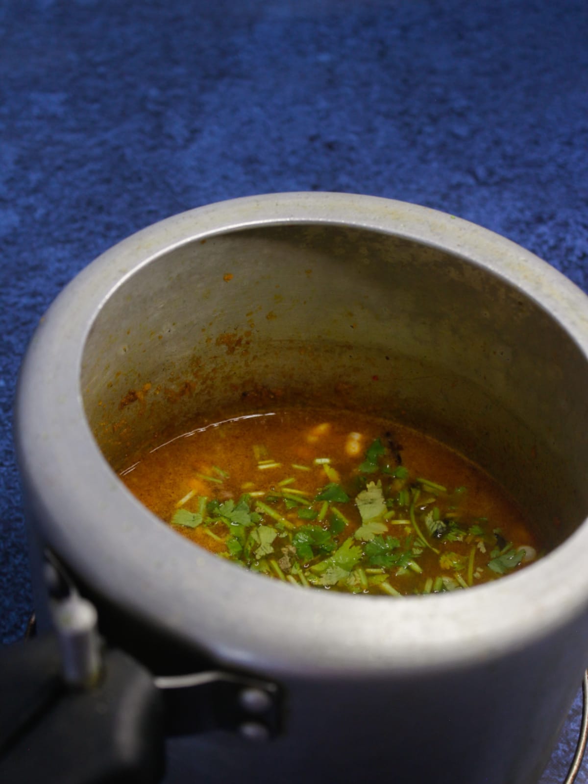 Add some water and chopped coriander leaves to the cooker and cook it until 6-7 whistles