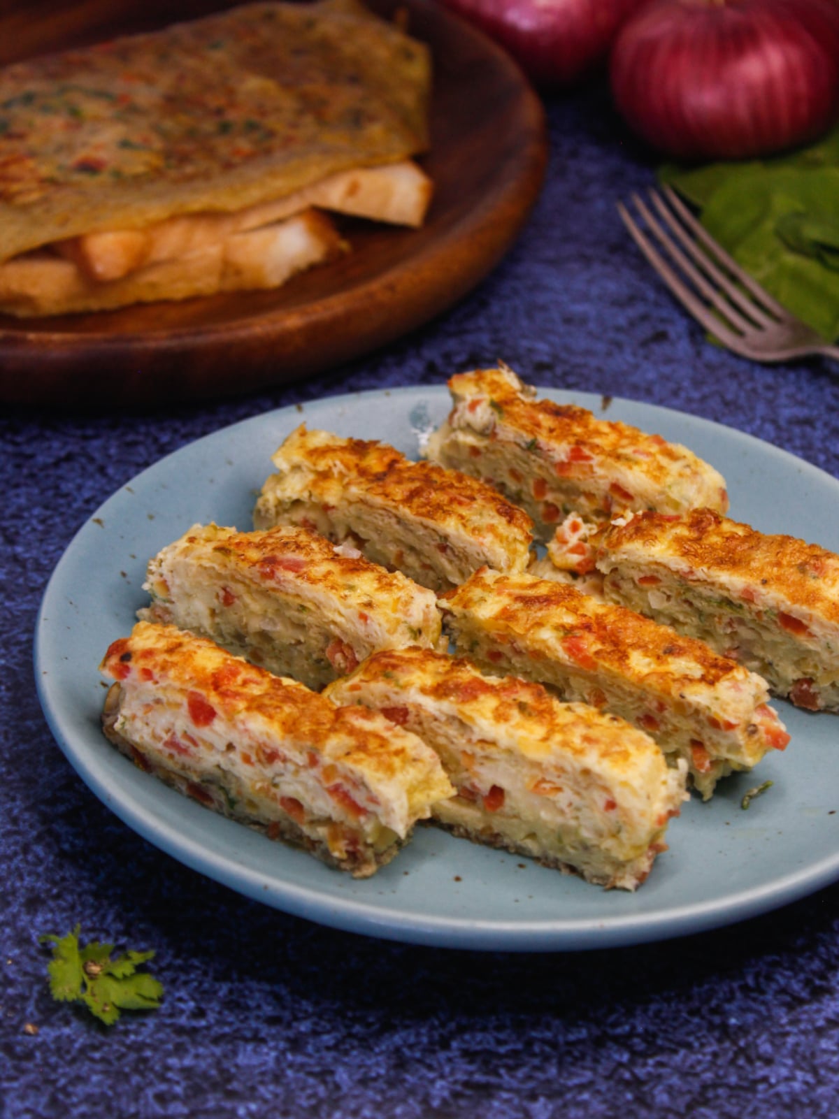 Cheesy Egg Roll served hot on a plate with some bread slices