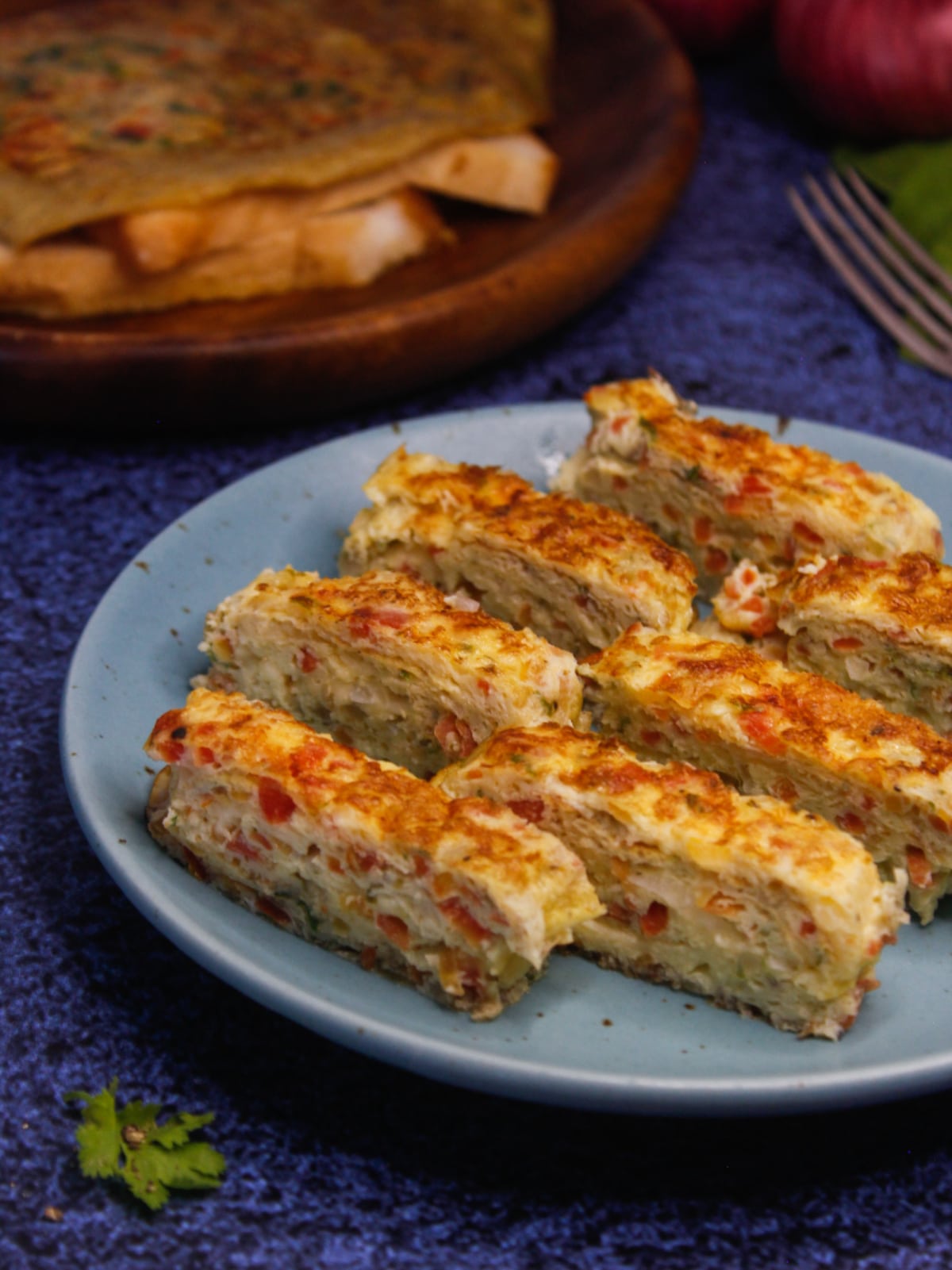 Yummy Cheesy Egg Roll can be enjoyed directly with fork or paratha