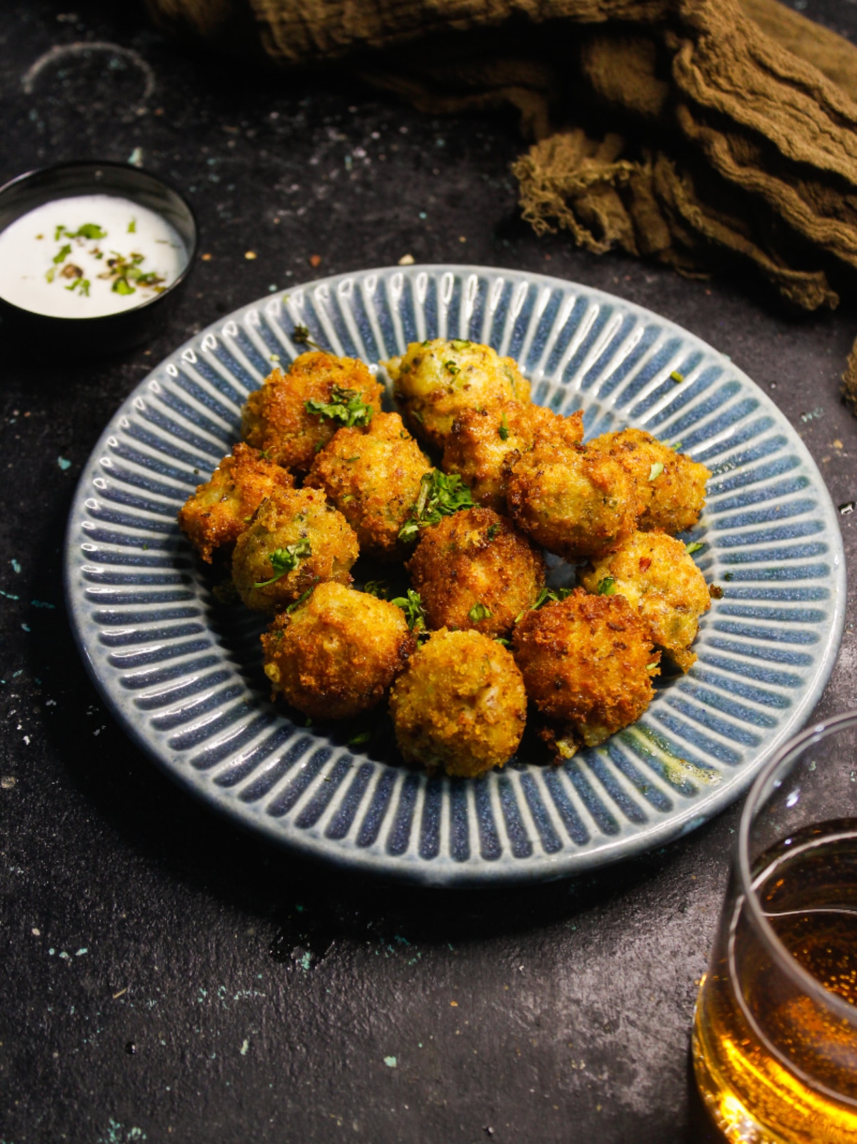 Top view image of Crispy Fried Cheesy Potato Balls with curd