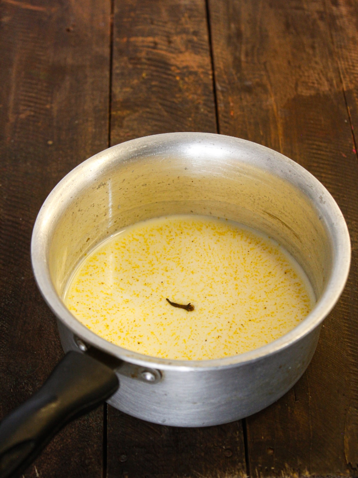 Add clove to the milk