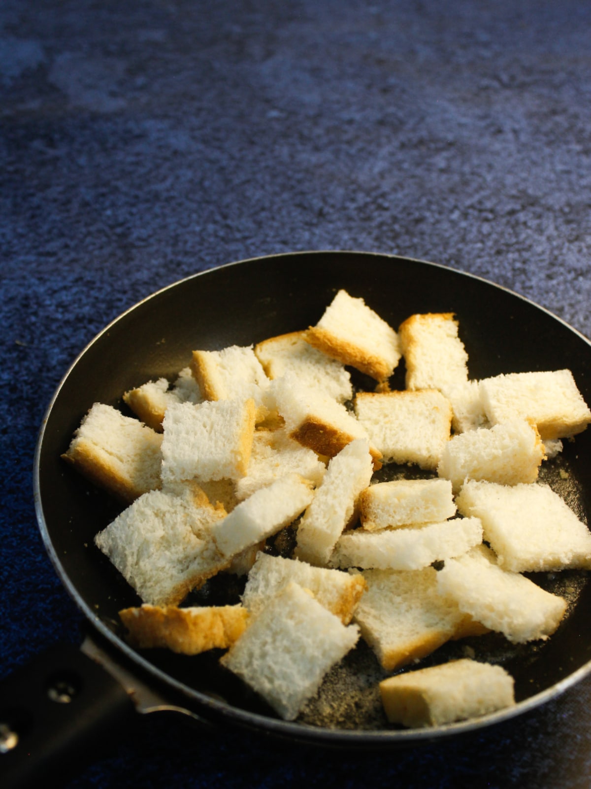 Add bread cubes to the pan