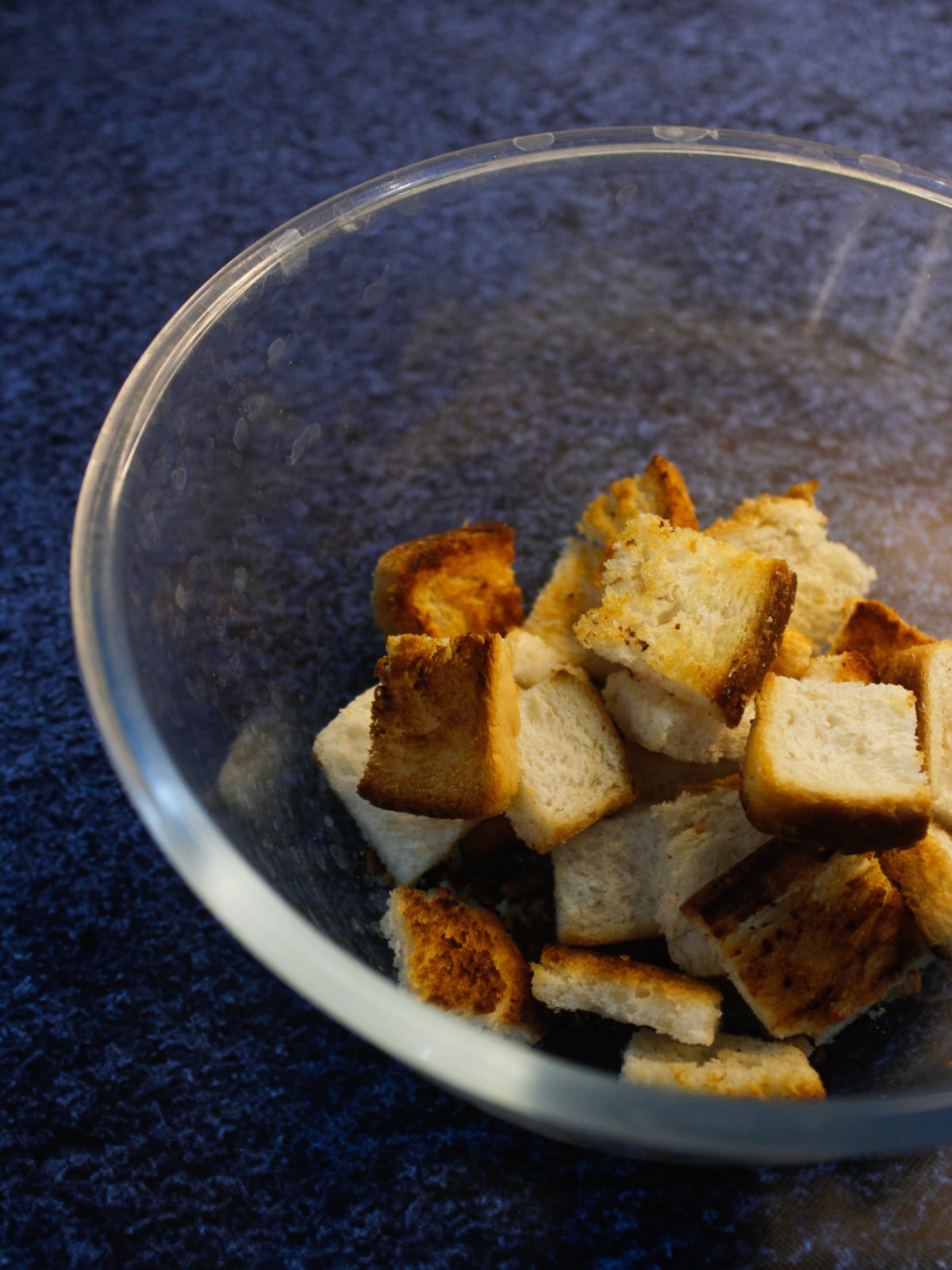 Transfer the bread cubes into the bowl and keep aside